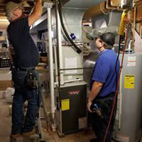 Northern Comfort Heating and Cooling technicians working on a heating system in Rochester and Walworth, NY